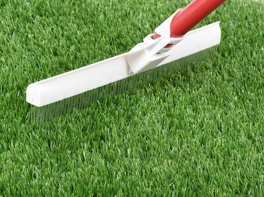 Brush for combing artificial grass and carpets